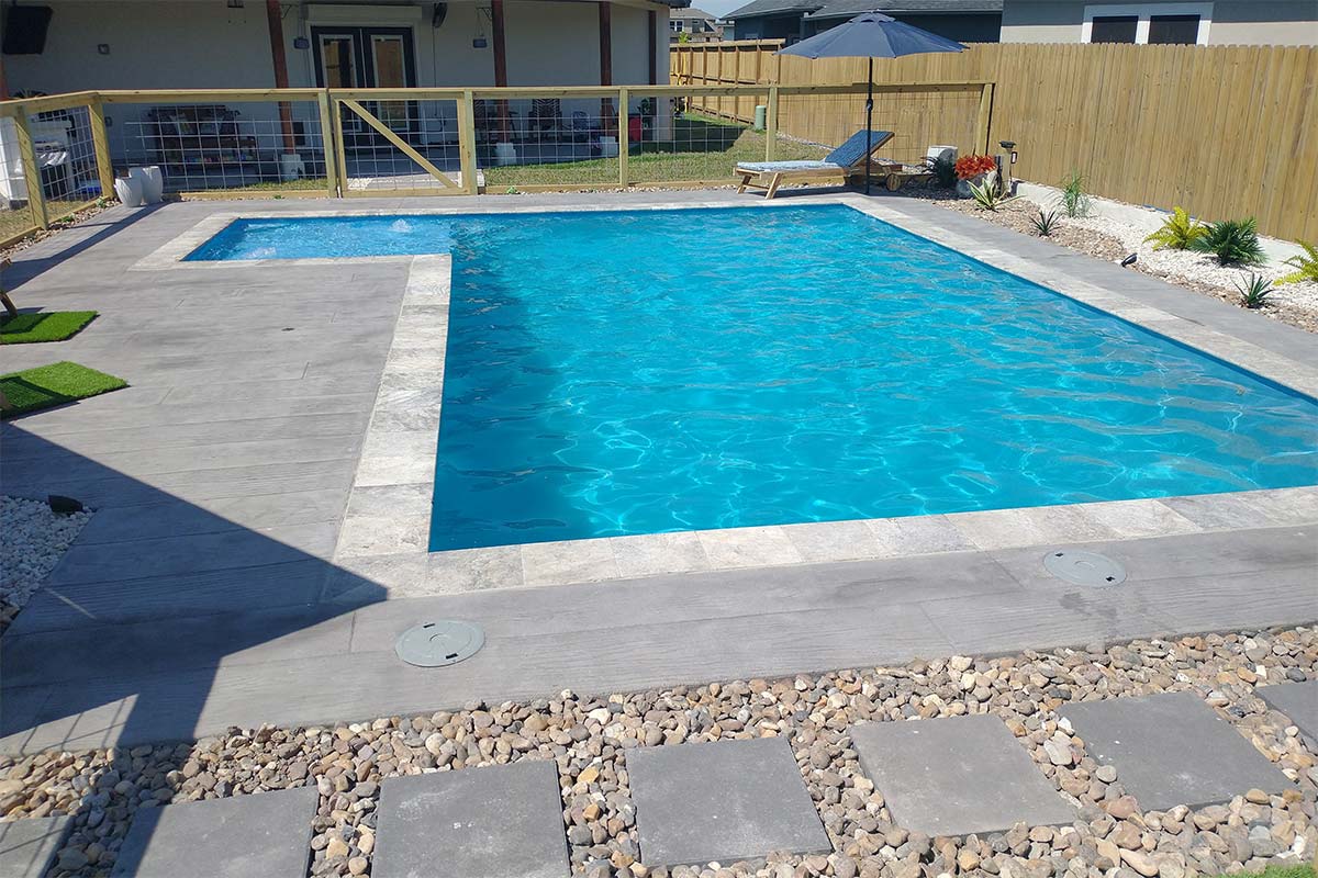 ICF POOL. FEATURES: L-SHAPED POOL W/ BUILT-IN SUNDECK. DECKING: STAMPED CONCRETE. CORPUS CHRISTI, TX.